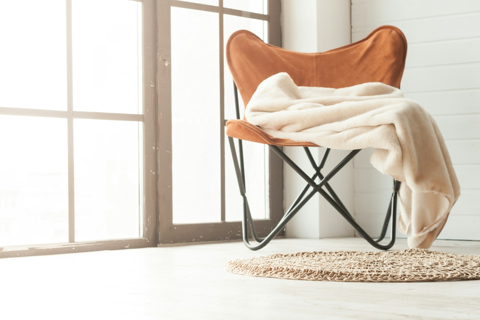 A leather chair beside a window