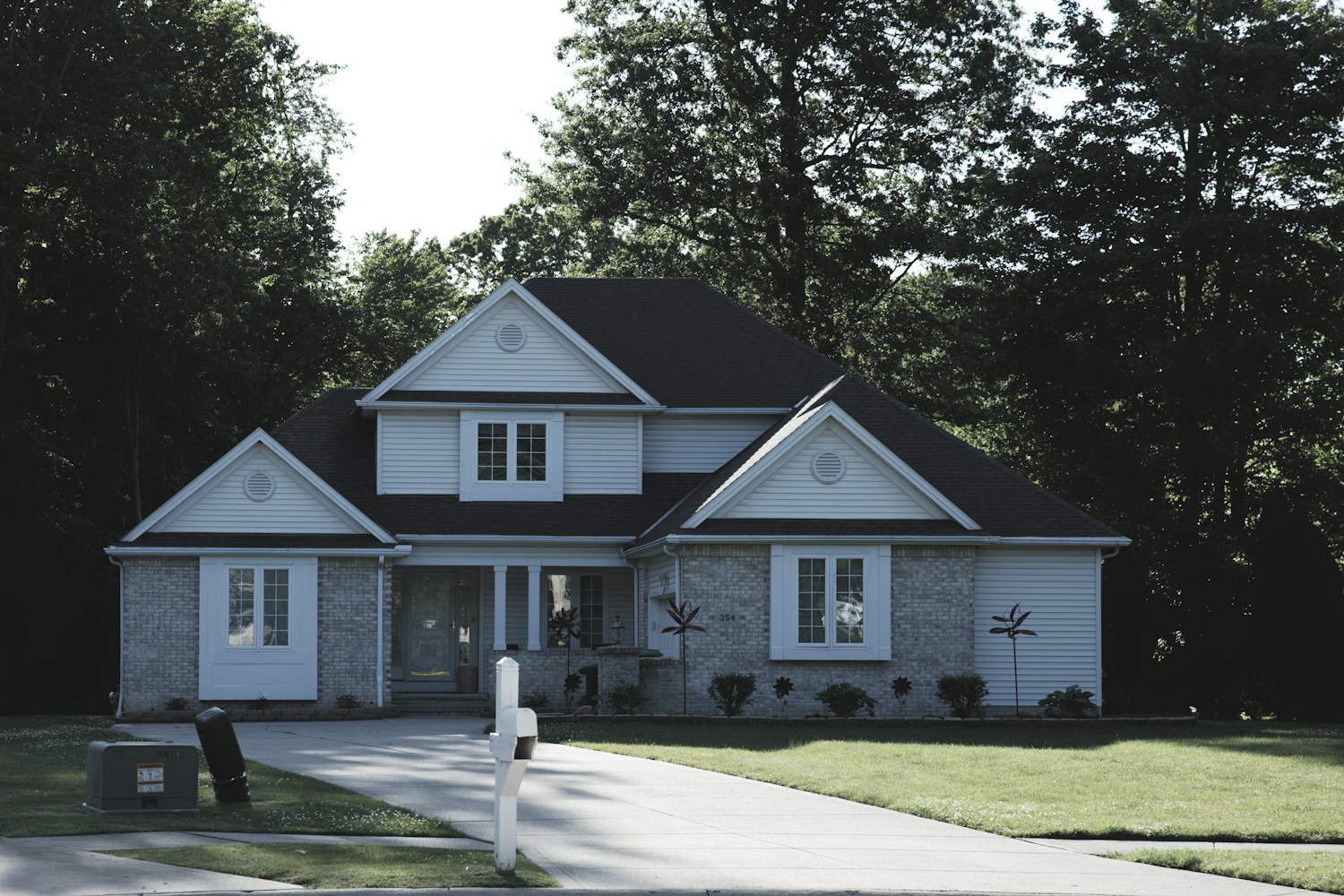 A house with a lawn and mature trees